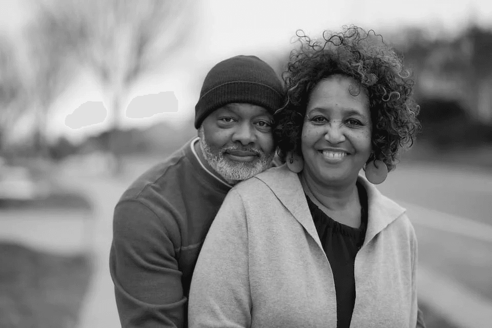 a man and woman smiling for a picture