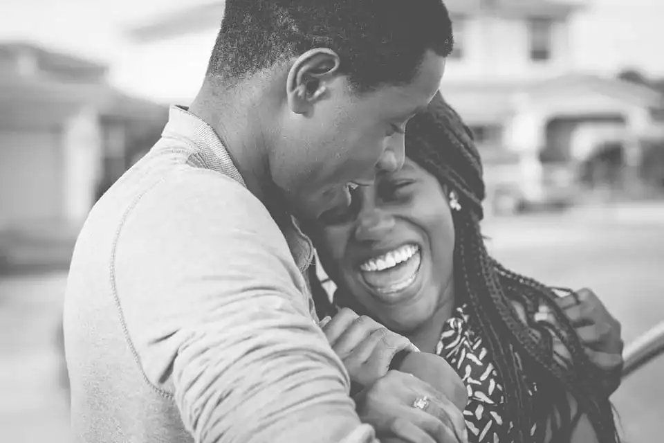 black couple hugging and smiling